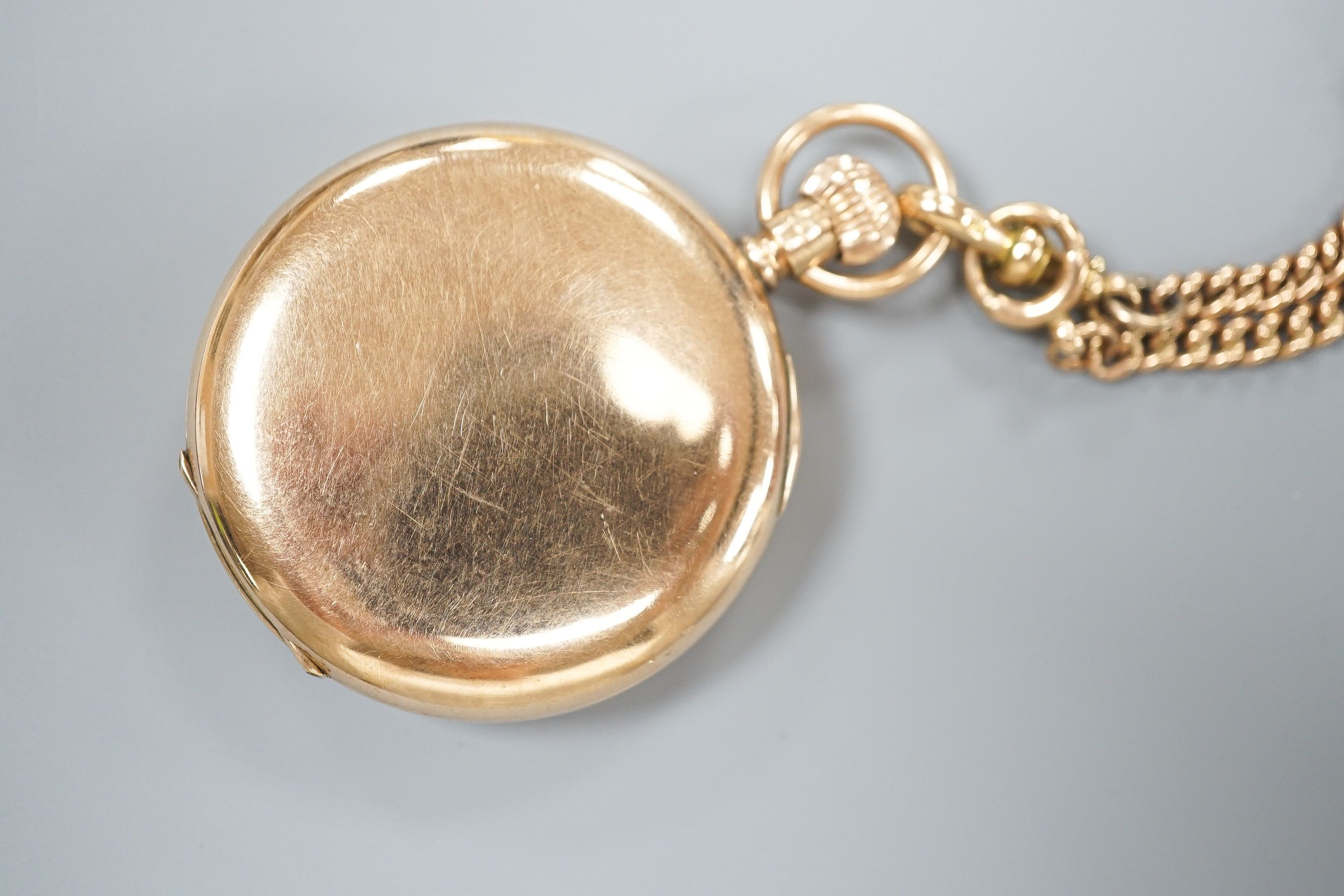 A George V 9ct gold half hunter pocket watch, 46mm, gross 74.9 grams, together with a 9ct gold cub link albert, 42cm, 21.2 grams.